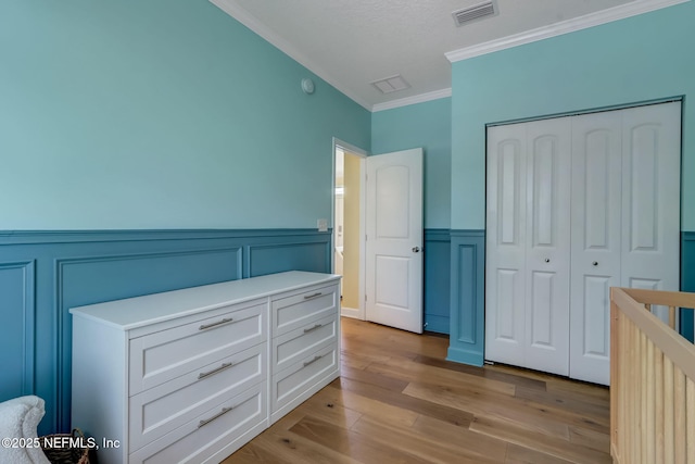 94202 Christopher Ln, Fernandina Beach, FL 32034 - bedroom with a closet, ornamental molding, and light hardwood / wood-style flooring