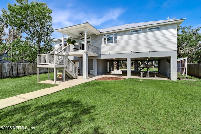 94202 Christopher Ln, Fernandina Beach, FL 32034 - back of house featuring ceiling fan, a yard, and a patio area