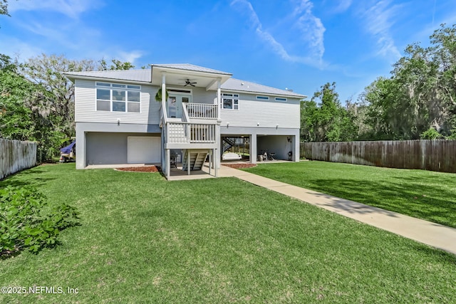 94202 Christopher Ln, Fernandina Beach, FL 32034 - rear view of house featuring ceiling fan, a garage, a patio, and a lawn