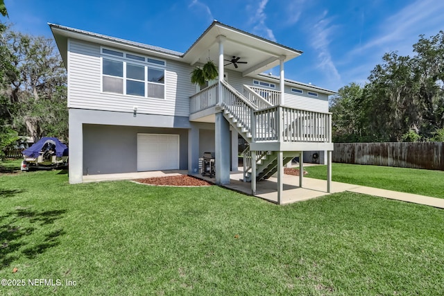 94202 Christopher Ln, Fernandina Beach, FL 32034 - rear view of property featuring a yard, a garage, a patio, and ceiling fan