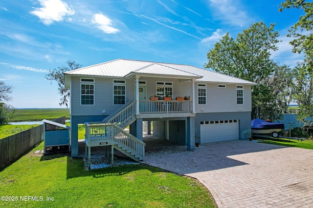 94202 Christopher Ln, Fernandina Beach, FL 32034 - view of front facade with a porch, a garage, and a front yard