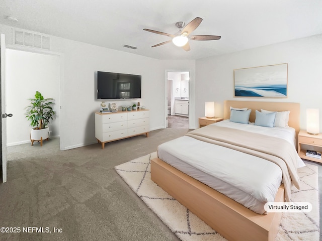 carpeted bedroom with ensuite bathroom and ceiling fan