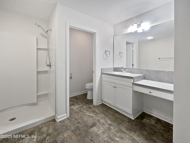 bathroom with vanity, walk in shower, and toilet