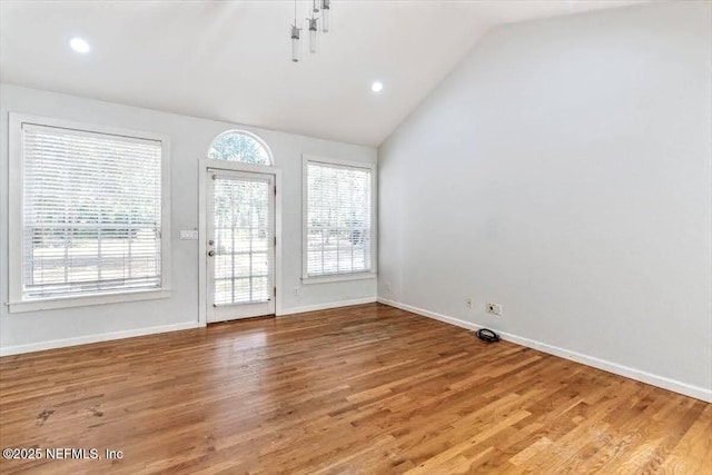 doorway to outside with lofted ceiling, light wood-style floors, baseboards, and recessed lighting