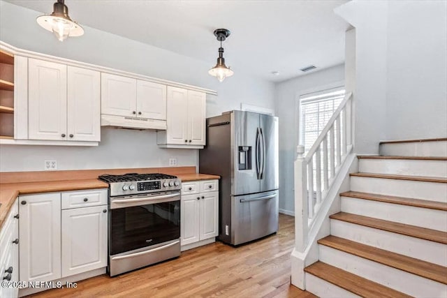 kitchen with stainless steel appliances, light countertops, under cabinet range hood, white cabinetry, and open shelves