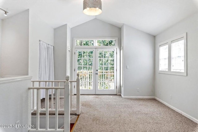 interior space featuring french doors, vaulted ceiling, and baseboards