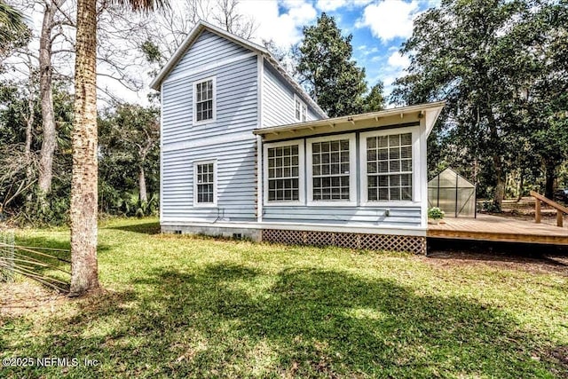 back of house with a yard and a wooden deck