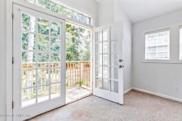 doorway with carpet flooring and baseboards