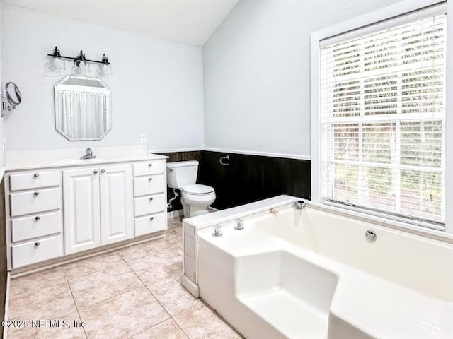 full bath with toilet, a garden tub, vanity, and tile patterned floors