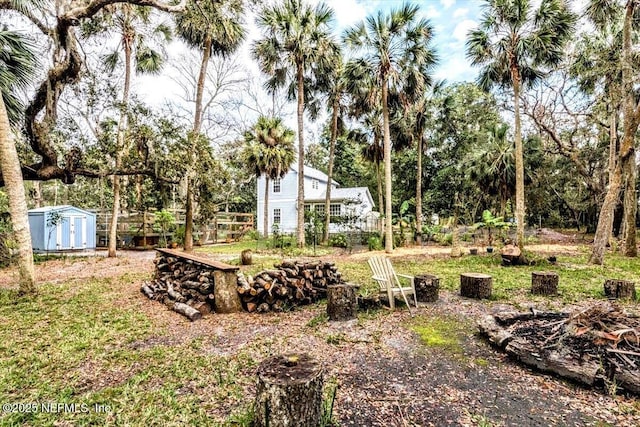 view of yard featuring a shed and an outdoor structure