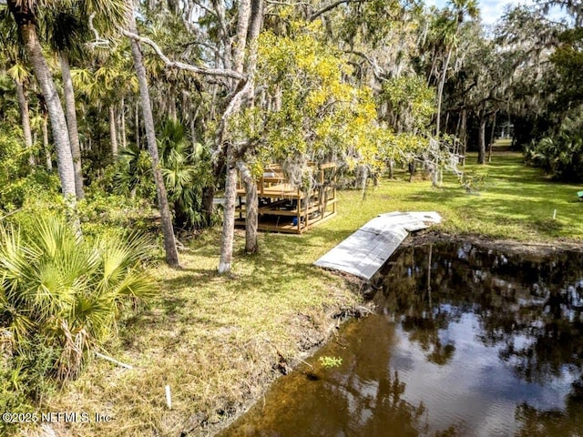 exterior space featuring a boat dock and a water view