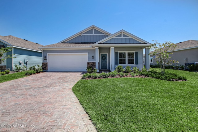 view of front of home with a garage and a front lawn