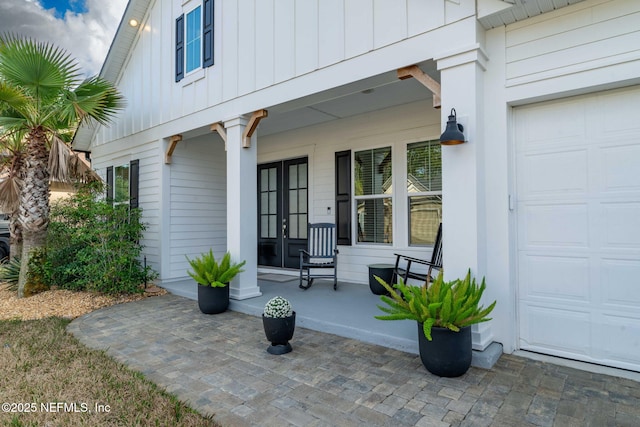 view of exterior entry with a porch