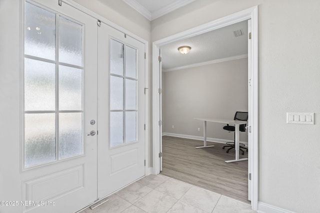 entrance foyer featuring crown molding and plenty of natural light