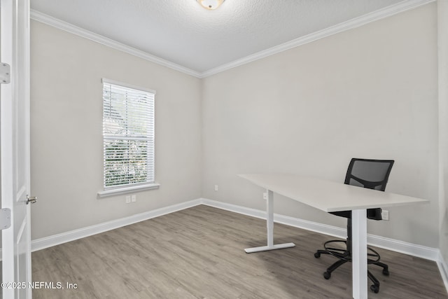 unfurnished office featuring hardwood / wood-style flooring, ornamental molding, and a textured ceiling