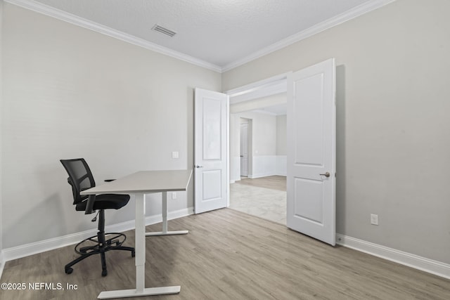 office area featuring wood-type flooring, ornamental molding, and a textured ceiling