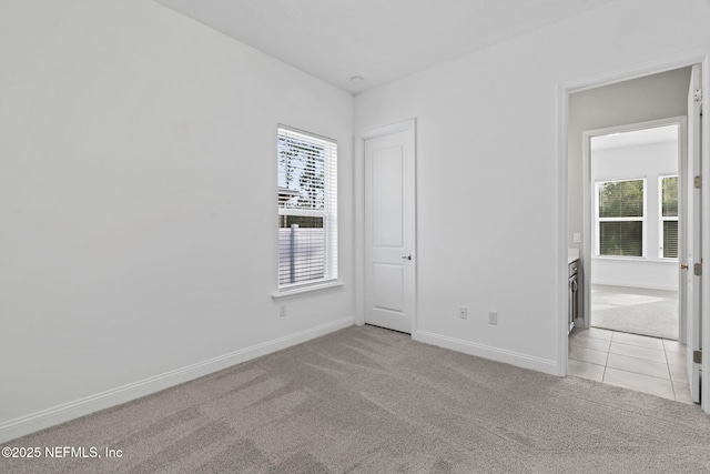 carpeted empty room with a healthy amount of sunlight