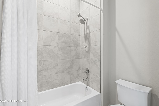 bathroom featuring toilet and shower / bath combo with shower curtain