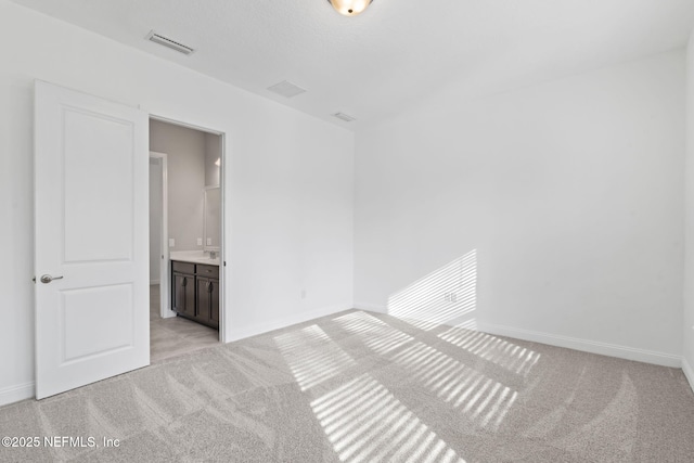 spare room with light carpet and a textured ceiling