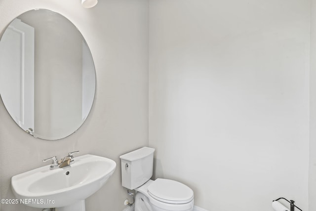 bathroom featuring sink and toilet