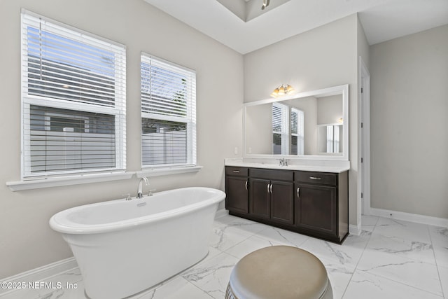 bathroom featuring vanity and a washtub