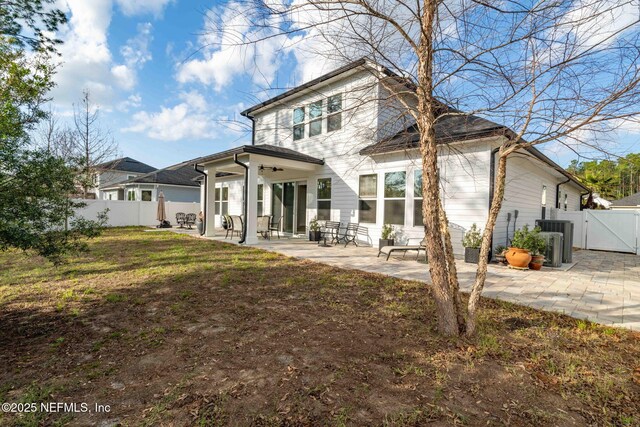 back of house featuring a yard and a patio