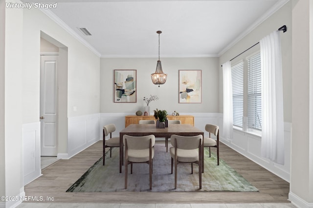 dining area featuring crown molding and hardwood / wood-style floors