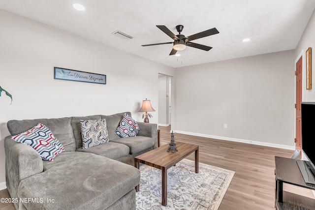 living room with hardwood / wood-style floors and ceiling fan