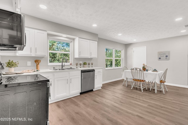 kitchen with white cabinetry, sink, stainless steel dishwasher, electric range, and a textured ceiling