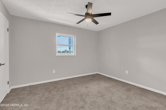 carpeted empty room with a textured ceiling and ceiling fan