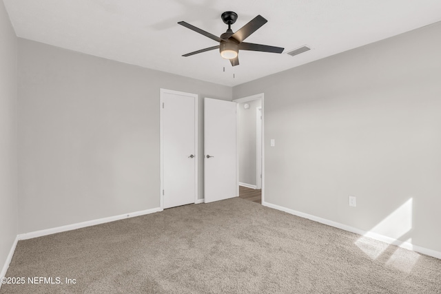 spare room with carpet floors and ceiling fan