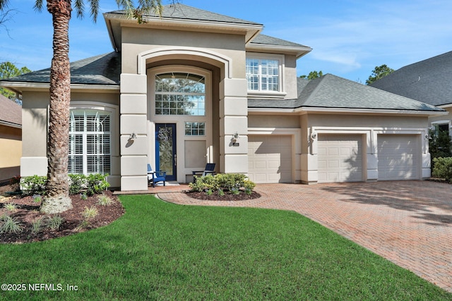 view of front facade with a garage and a front lawn