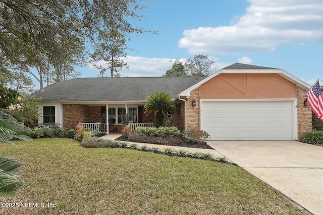 ranch-style home featuring a porch, a garage, and a front yard