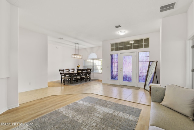 living room with light wood-type flooring and french doors