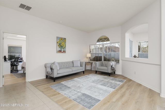 living room with a healthy amount of sunlight and light hardwood / wood-style floors