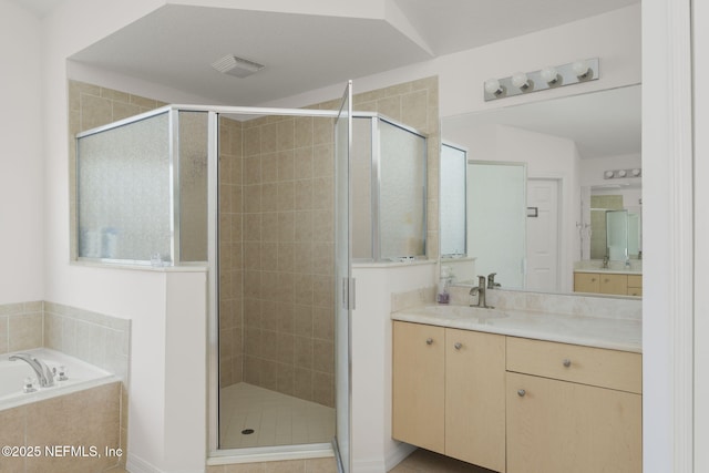 bathroom featuring vanity and shower with separate bathtub