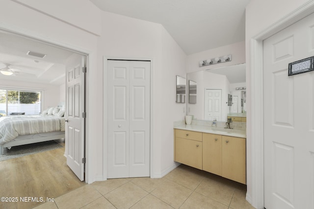 bathroom with tile patterned flooring, vanity, and ceiling fan