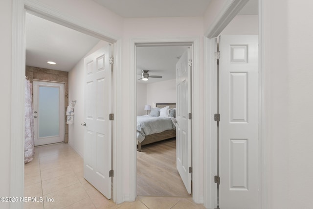 hallway featuring light tile patterned floors