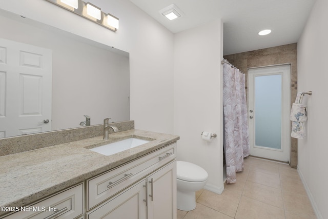 bathroom featuring vanity, tile patterned floors, and toilet