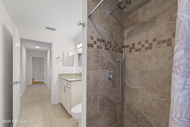 bathroom with tile patterned flooring, vanity, and curtained shower