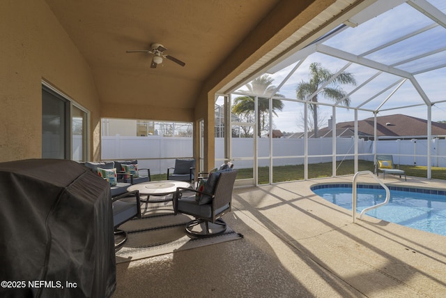 view of pool featuring grilling area, glass enclosure, and a patio area