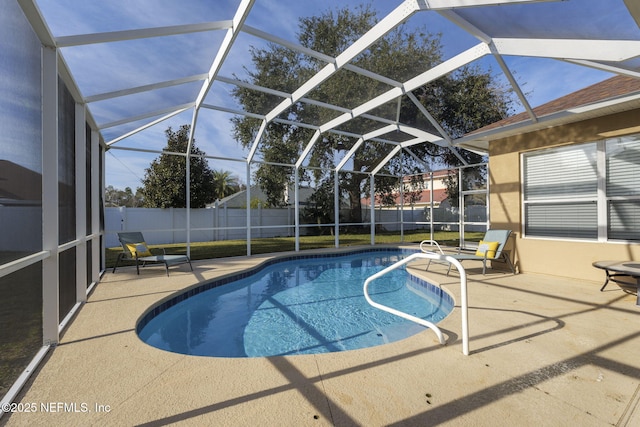 view of swimming pool featuring a patio and a lanai