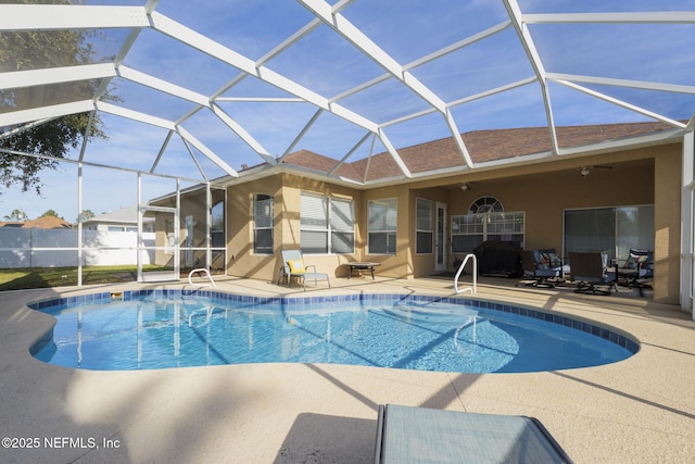 view of swimming pool with a lanai, a patio area, and ceiling fan