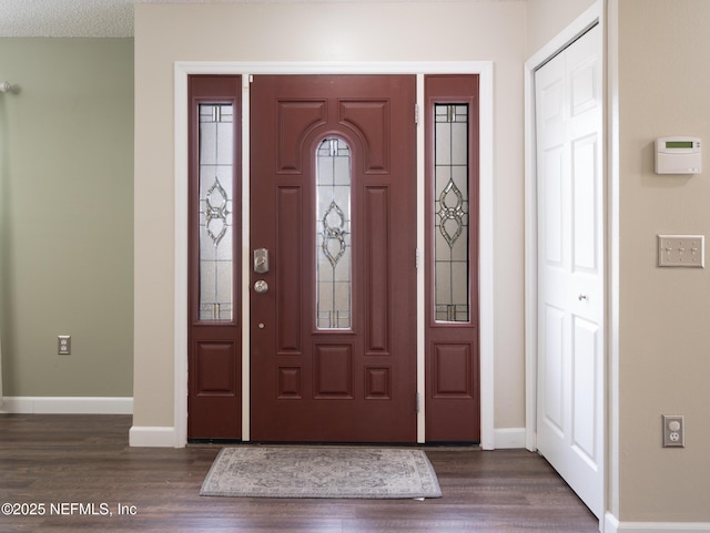 foyer entrance with dark hardwood / wood-style floors