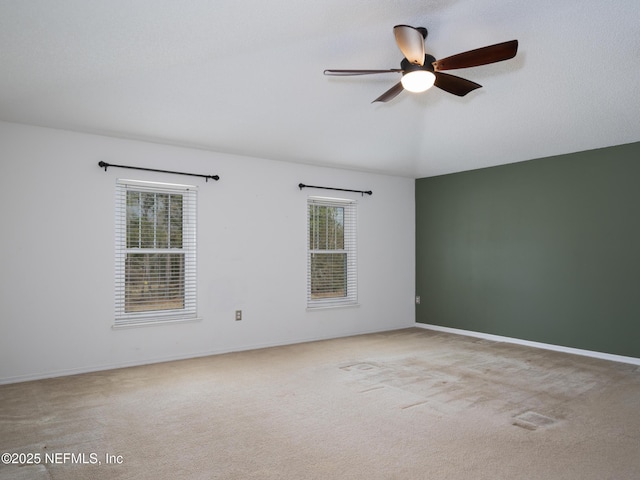 carpeted empty room featuring ceiling fan