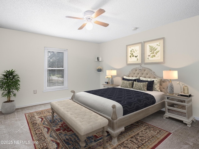 carpeted bedroom with ceiling fan and a textured ceiling