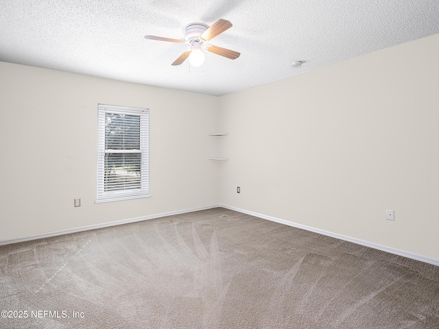 carpeted empty room with ceiling fan and a textured ceiling