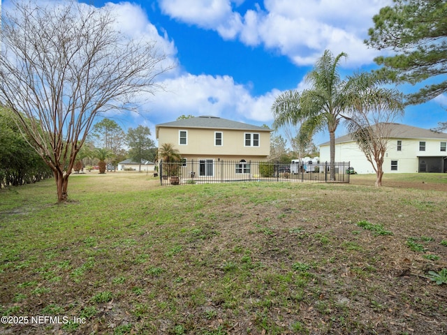 rear view of house with a lawn