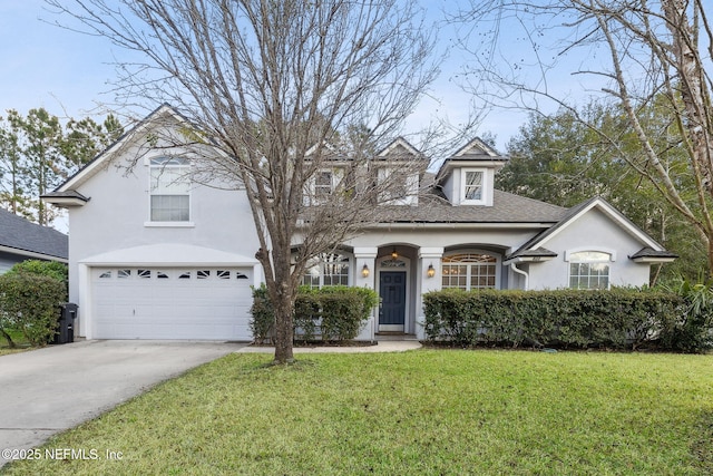 829 Songbird Dr, Orange Park, FL 32065 - view of front of house featuring a garage, stucco siding, concrete driveway, and a front lawn