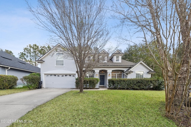 view of front of home with a garage and a front yard